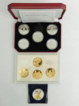 A Queen Mother 1980 coin set, a Legend of King Arthur coin set and a 2008 Liberty Silver Dollar.