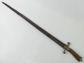 An 18th/19th century German hunting dagger with an antler handle and dog design guards. Blade 58 cm.