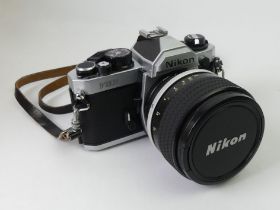 A Nikon FM2 35 mm camera and lens.