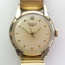 Longines manual wind gold filled gents watch on an expanding strap. 36.7 mm wide including the