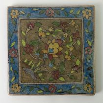 A large Persian pottery tile 24 cm square.