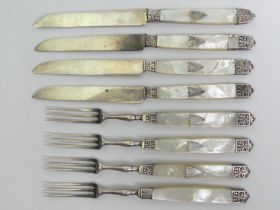 A set of Edwardian silver and abalone dessert knives and forks, 273 grams gross, 19cm long.