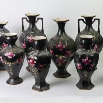 Eleven Edwardian black pottery vases with Roses design. 37 cm tallest. Collection only.