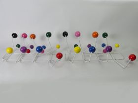A pair of Vitra Eames multi-coloured ball coat hangers, 46cm x 30cm.