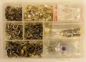 A box of silver clasps, jump links and earring backs.