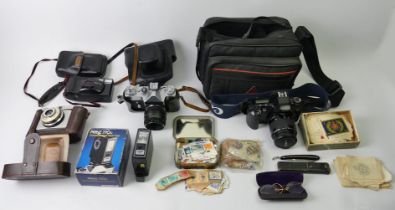 A box of cameras including a Canon Eos 500, Zenit, Ilford and paraphernalia.