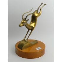 1970's stylised brass antelope figure on an oak plinth, 35cm.