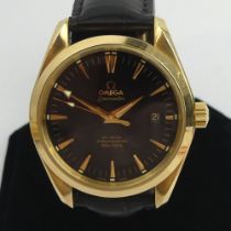18ct gold Omega black dial Seamaster co-axial chronometer, on a Omega black leather strap with an