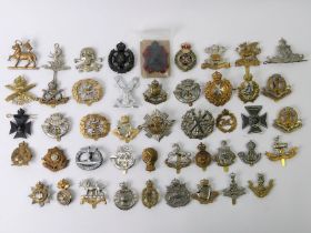 47 various military cap badges, including The Buffs, Dragoon Guards and Middlesex regiments.
