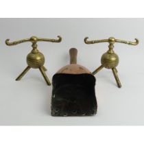 Christopher Dresser brass fire dogs and a Victorian copper money scoop with an oak handle 37cm.
