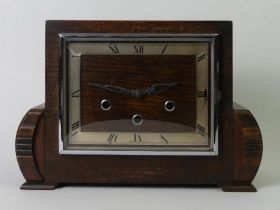 A 1930's oak Westminster chime mantle clock with key and pendulum. 32 x 23 x 12 cm.