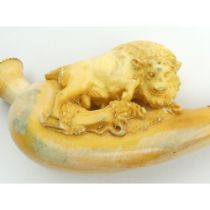 A meerschaum cheroot holder depicting a bison with a snake with original amber mouthpiece in half