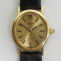 Tudor gold plated manual wind ladies watch witha tigers-eye set button. 26.4 mm wide including the