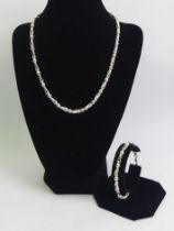 A matching sterling silver necklace and bracelet, 67 grams. 42 & 22 cm x 5.5 mm.