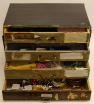A three drawer chest of jewellery and stone items, 39cm x 25cm x 27.