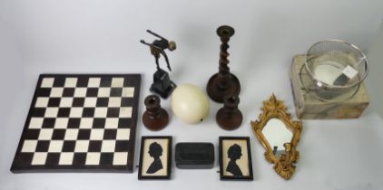 A box of mixed items including an Art Deco style bronze figure, chess board and mirror.