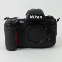 A boxed Nikon F100 35mm camera.