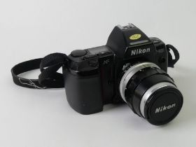 A Nikon F-801 35mm camera and lens.