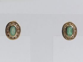 A pair of 9ct gold emerald and diamond earrings, 7.8mm x 9.5mm.