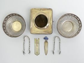 Two silver book page markers, two silver bon bon dishes, two pairs of sugar tongs and a silver