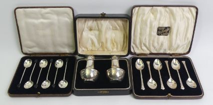 Two cased sets of silver spoons, Birm. 1902 and Sheff. 1932 along with a silver cruet set. 134