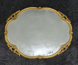 An ornate brass framed Edwardian style mirror. 45 x 60 cm.