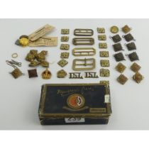 A box of military buttons, badges and buttons.