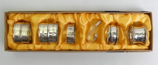 Eight silver napkin rings, various dates and makers including a silver golf club design example.