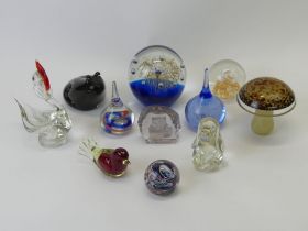 Eleven glass paperweights including a Wedgwood frog.