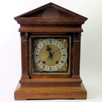 A late Victorian oak striking mantel clock of architectural form. 40 x 31 x 18 cm.