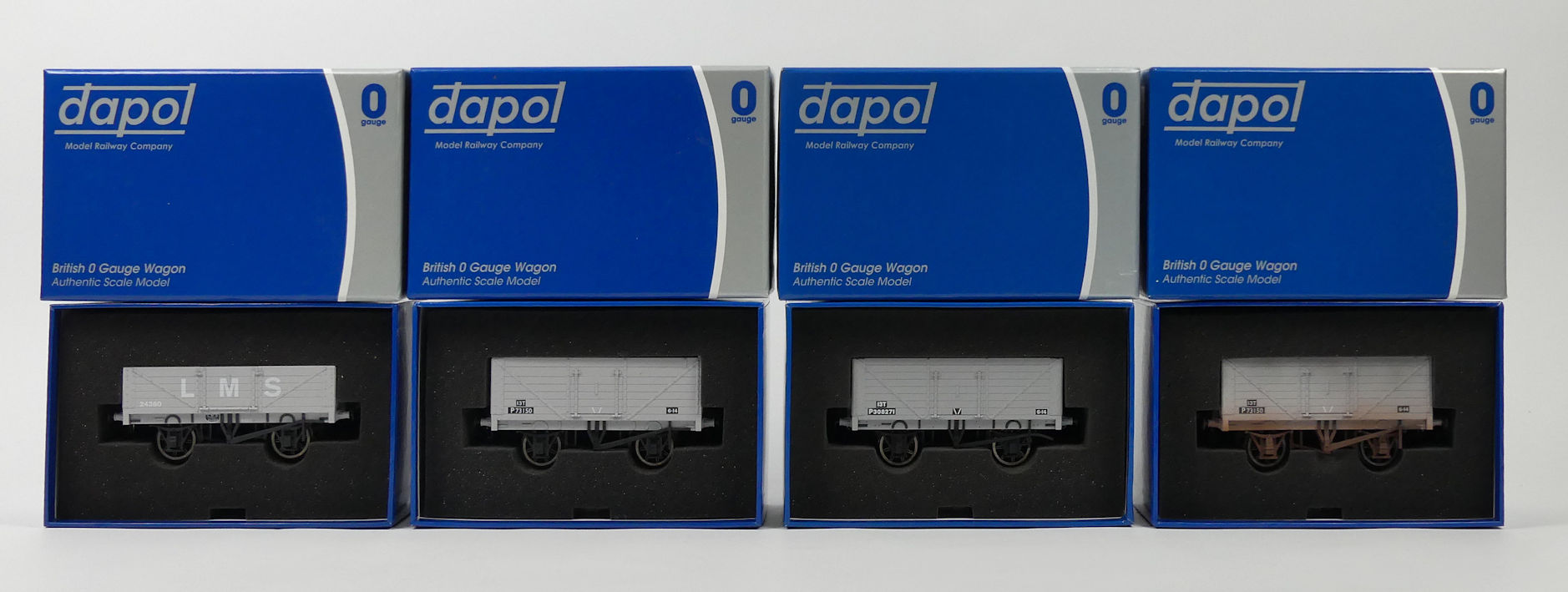 Four boxed Dapol 0 gauge wagons including BR P308271, eight plank open wagon, BR seven plank open