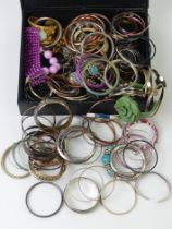 A case of bangles and bracelets including rolled gold.