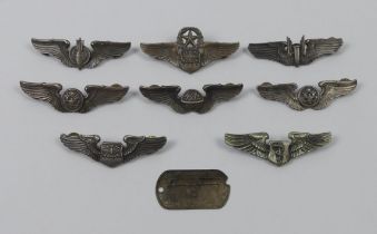 Eight US WWII aircrew wings, clutch backs and a dog tag to Nielson Arthur, each approximately 75mm