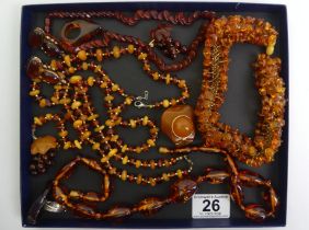 A collection of amber jewellery, some set in silver including rings and earrings.