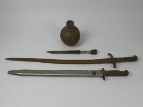 Three old bayonets and a grenade, longest bayonet 69.5cm.
