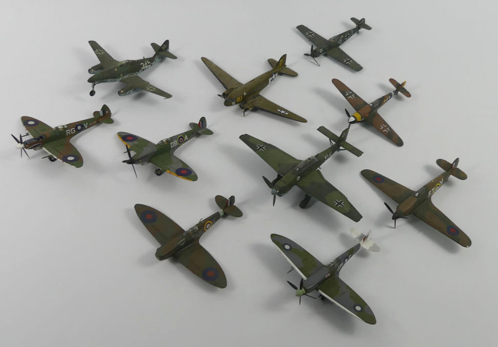 Ten unboxed diecast warplanes.