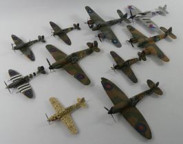 Ten unboxed diecast warplanes.