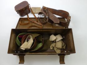 M104 MK1 ammunition box containing leather cased binoculars, belts and a First Aid dressing.