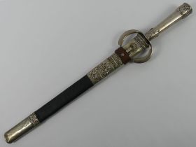 An Arabic bayonet in scabbard with white metal fittings, blade 42cm.