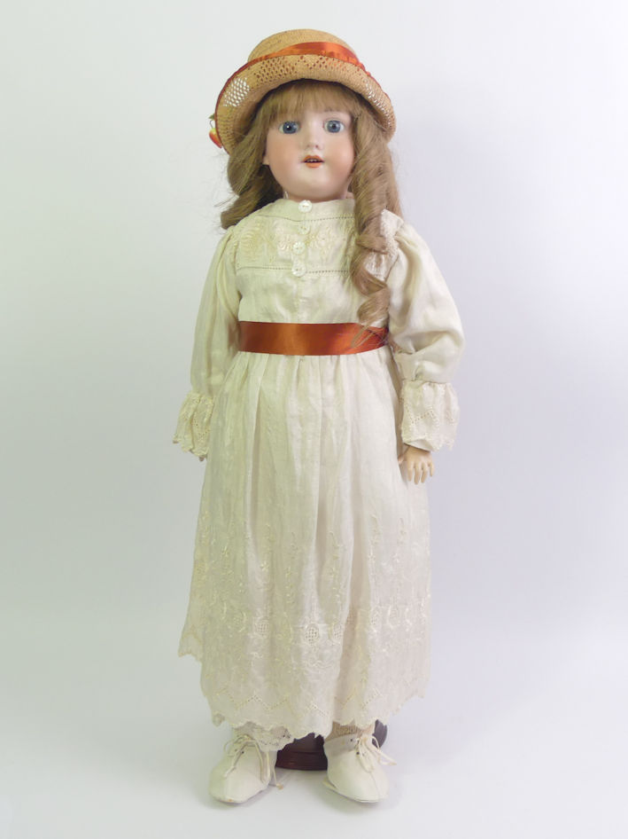 An Armand Marseille bisque head doll number 390. 58cm tall.