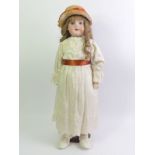 An Armand Marseille bisque head doll number 390. 58cm tall.