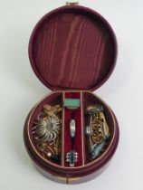 A leather jewellery box and contents including a silver and chrysoprase ring.