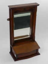 An Edwardian walnut hanging mirror. 62 x 34 x 18.5cm.