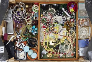 A box of mixed costume jewellery including Murano glass and other necklaces.