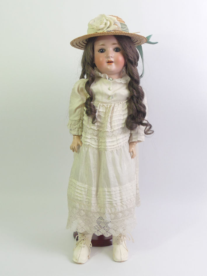 A Simon and Halbig bisque head porcelain doll number 1909-4 1/2. 56cm tall.