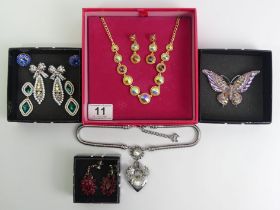 Butler & Wilson crystal heart and bow necklace along with earrings and a necklace.