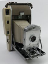 A Polaroid 800 camera in a fitted case complete with flashgun and instructions.