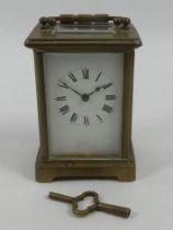 Early 1900's brass carriage clock and key. 14.5cm high.