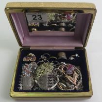 A box of jewellery including silver rings and pendants.