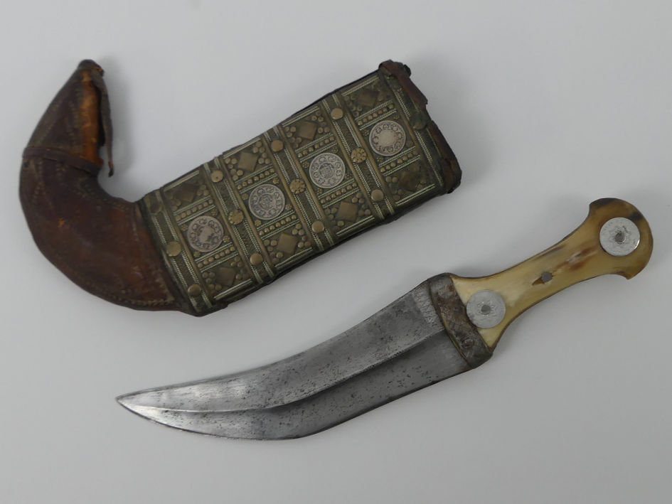 A middle-eastern dagger in sheath, metal belt and a rug depicting camels in the desert and a brass - Image 3 of 4